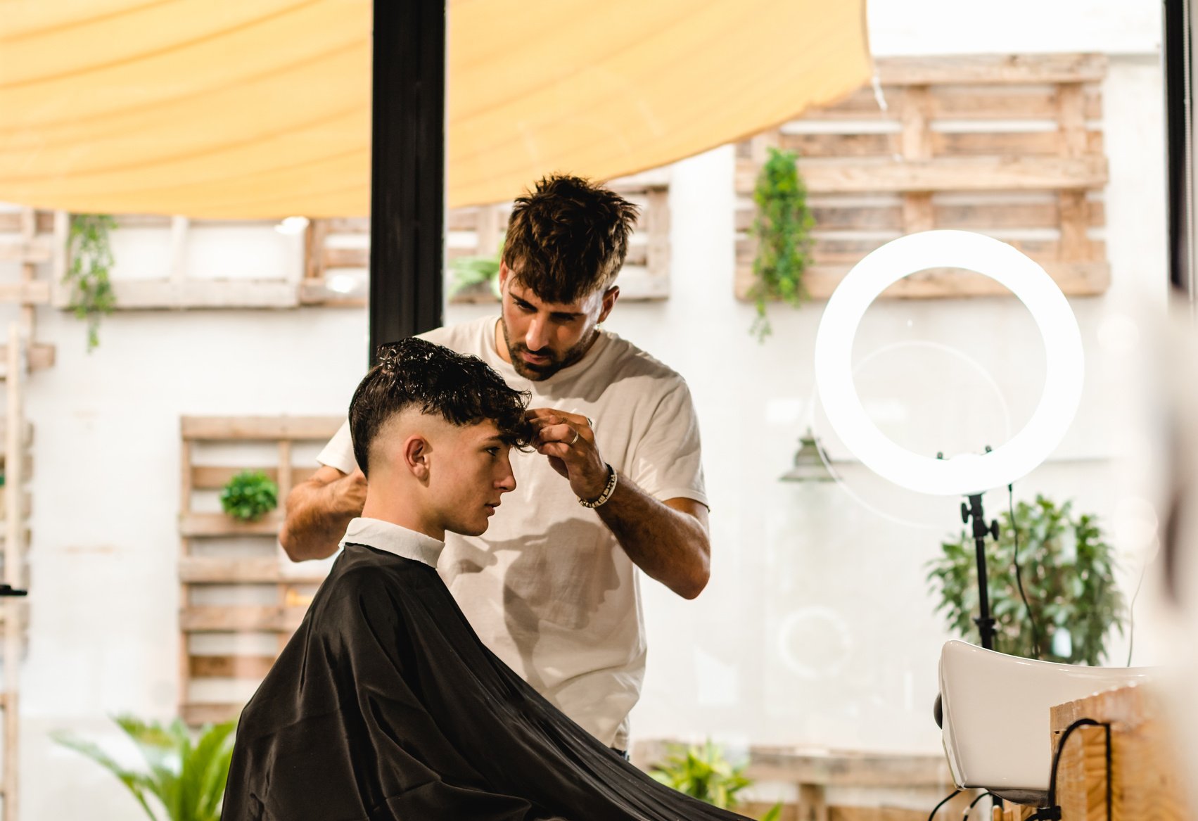 Teenager Getting a Haircut in a Bright Barbershop